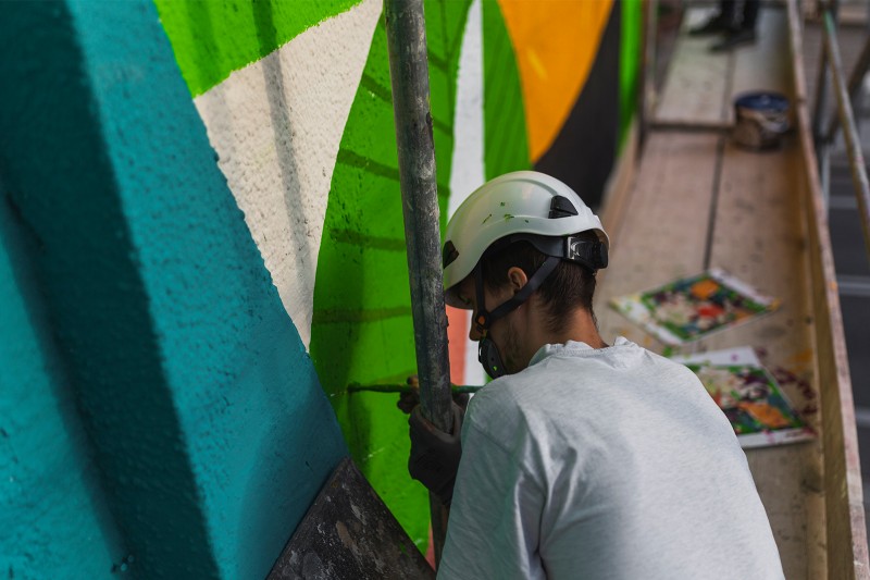 Artysta malujący mural reklamowy dla innogy na Tamce w Warszawie | Zielona Energia dla Warszawy | Portfolio
