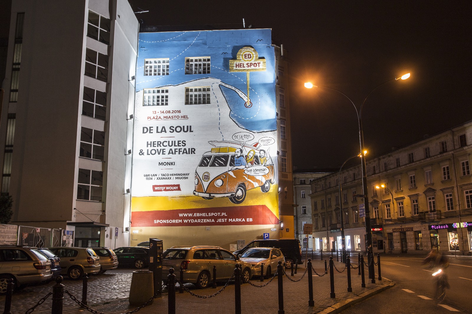 Dom Towarowy Bracia Jablkowscy seen from Krucza street with a mural advertising the EB Hel Spot festival | EB Hel Spot | Portfolio