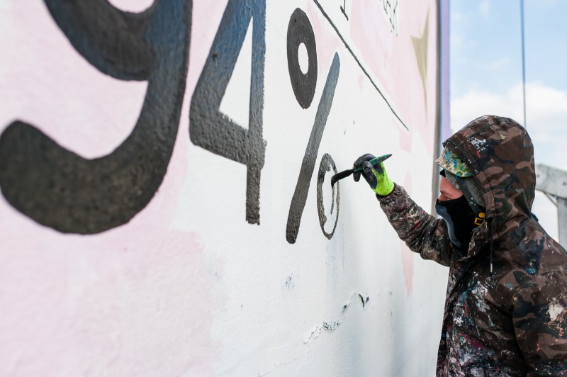 Hand painting an advertisung mural Warsaw city centre | YOPE | Portfolio