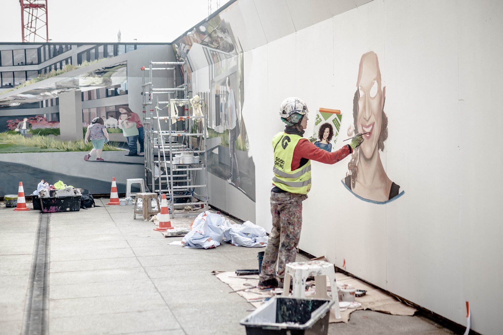 Malarz malujący mural na płocie dla klienta Skanska | Generation Park | Portfolio